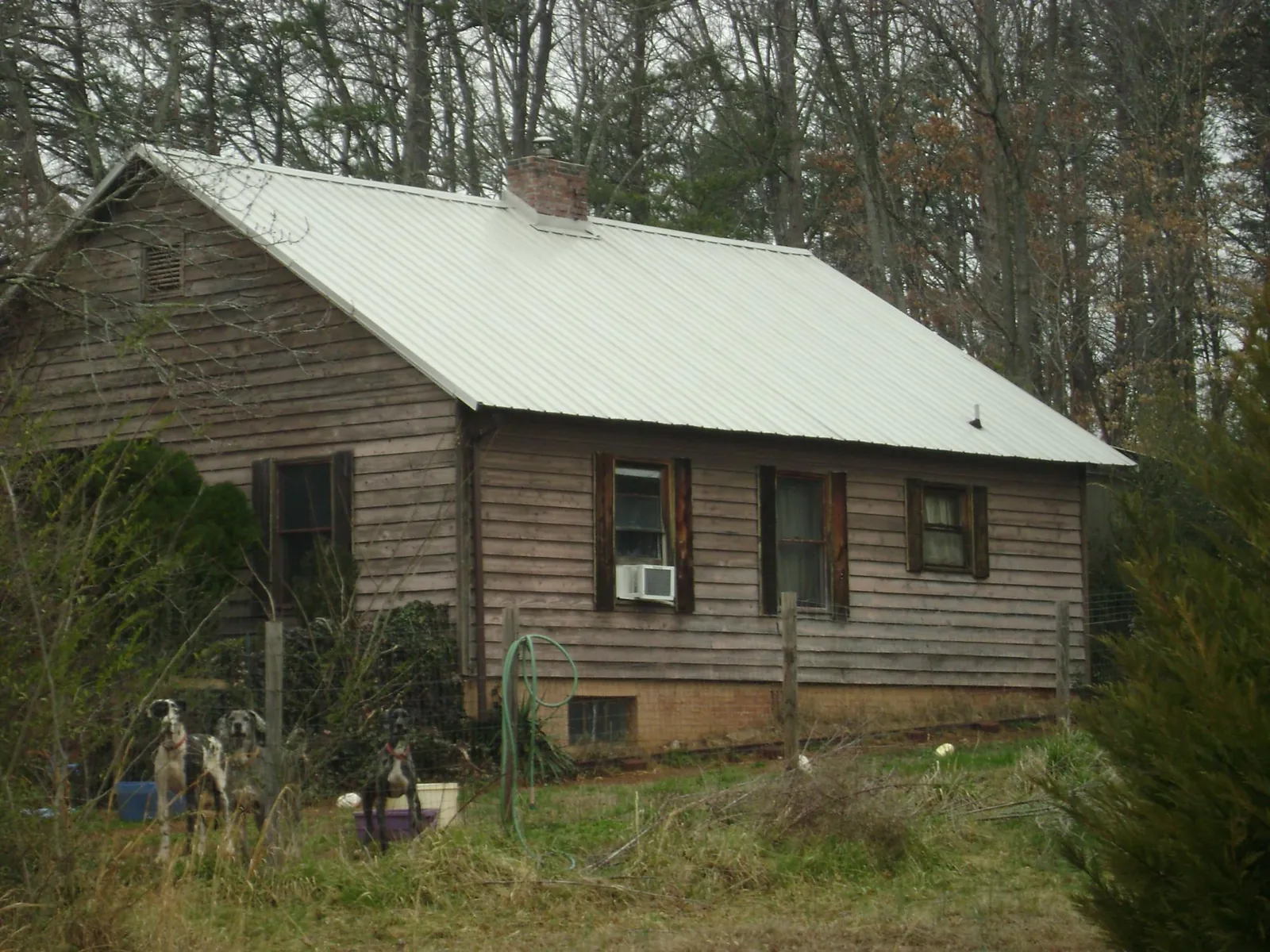 White metal roof on an old wood sided farmhouse, from a Metal Roof Installation job in Richville